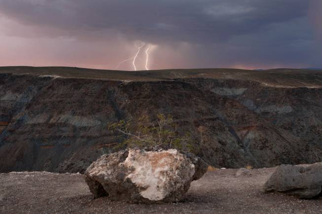 Lightning strikes over a ridge as a storm passes though Death Valley National Park in California just after sunset July 21, 2009.