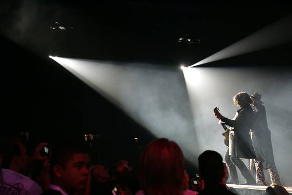 Joe Perry, Steven Tyler, spot-lit.