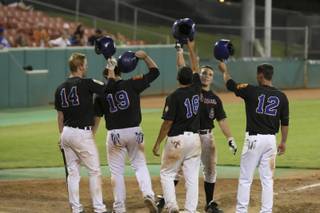 Bishop Gorman's Johnny Field (2) celebrates his grand slam with teammates Saturday during the American Legion state championship game against Reno at Wilson Stadium. The Titans won the game 12-3 against the Knights.