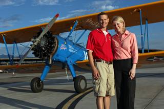 Matt and Tina Quy pose with their biplane, the Spirit of Tuskegee, at the North Las Vegas Airport in North Las Vegas on July 22, 2009.