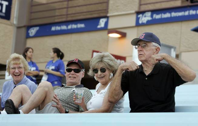 Bob Sweet, right, mugs for the camera Monday at Cashman as his friends encourage him. Sweet said he didn't know it was a doubleheader ahead of time and couldn't remember ever attending one previously. "We just came to watch a game," he said.  