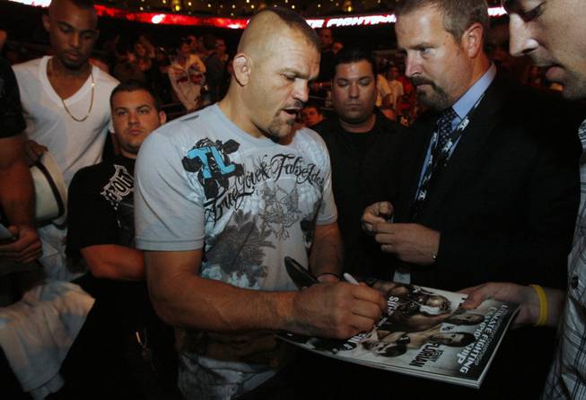 Fans of mixed martial arts and the UFC, Ultimate Fighting Championship gather at the Wachovia Center on Saturday evening August 8, 2009 for a night of fighting. Pictured is fighter Chuck Liddell signing autographs for fans as he enters the seating area before the start of the fights.