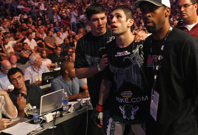 Fans of mixed martial arts and the UFC, gather at the Wachovia Center on Saturday evening August 8, 2009 for a night of fighting. Battle between welterweights on the main card, Johnny Hendricks and Amir Sadollah. Sadollah is escorted away from the Octagon after his defeat.