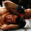 Fans of mixed martial arts and the UFC gather at the Wachovia Center on Saturday evening August 8, 2009 for a night of fighting. Battle between lightweights. BJ Penn, defending Lightweight champion, chokes Kenny Florian moments before the referee called the fight.