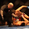 The referee stops the action as Brian Bowles attacks Miguel Torres as the two face off for the world