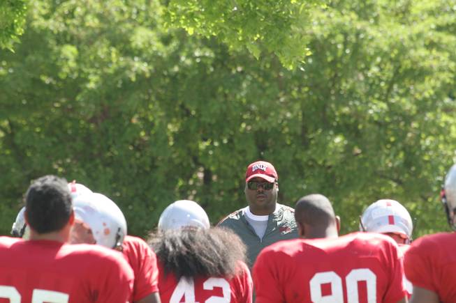 Former Dallas Cowboys defensive tackle Leon Lett, who is on the UNLV staff as a volunteer office assistant, looks on before a defensive line drill during Thursday's practice at Broadbent Park in Ely. Lett is not an official coach on the Rebels staff, but offers priceless tidbits alongside UNLV line coach Andre Patterson.