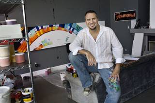 Artist Jerry Misko poses at home before finishing a painting for his new show, 
