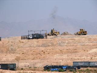 A Boulder Disposal truck dumps a load at the Boulder City Landfill on Friday. The city has been given permission to expand the almost-full dump vertically by 25 feet. The Eldorado mountains are visible in the background.