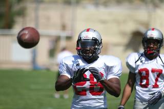UNLV running back Bradley Randle prepares to catch a ball shot out from the Jugs machine during the middle portion of Friday morning's practice at Broadbent Park in Ely.
