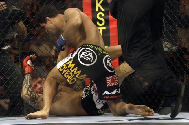 Gegard Mousasi, top, punches Renato "Babalu" Sobral during a Strikeforce mixed martial arts Light Heavyweight Championship match on Saturday, Aug. 15, 2009, in San Jose, Calif. Mousasi won by TKO in the first round to win the championship.