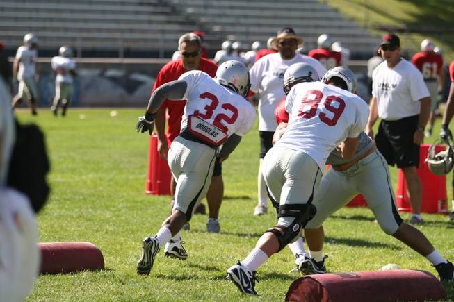 UNLV running back Channing Trotter (32) runs successfully thanks to the block of tight end Austin Harrington (89) during the Oklahoma drill on Sunday, Aug. 16, at Broadbent Park in Ely.