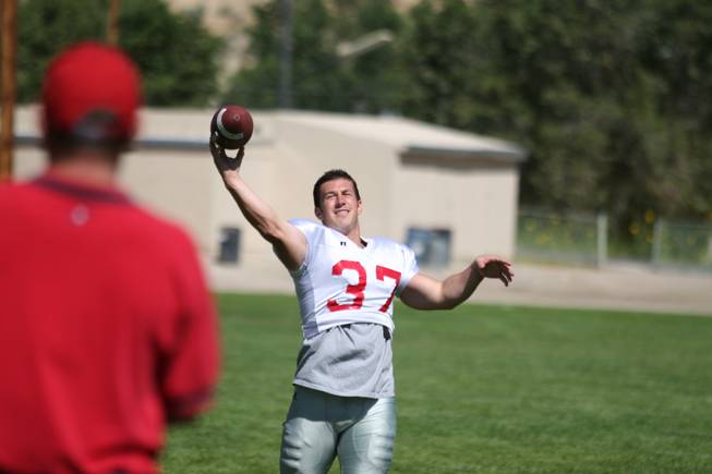 UNLV kicker Kyle Watson throws a pass while killing time Aug. 17 during practice at Broadbent Park in Ely.