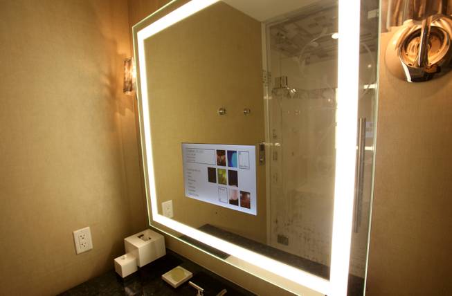A TV is seen embedded in the mirror in the ...