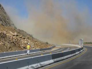 Crews blast rock on I-15 in California near the Nevada border as part of the widening of the freeway.
