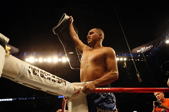 Juan Diaz of Houston holds up the NABO Junior Welterweight title belt after he defeated Paulie Malignaggi in a decision in 12 rounds on Aug. 22, 2009, in Houston.