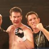Best-selling author Matthew Polly, center, poses with his fight crew of Randy Couture (left-to-right