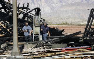 Fire investigators look over an electrical meter at a fire scene in the Mountain's Edge master-planned community in the southwestern Las Vegas Valley Monday, Aug. 24, 2009. 