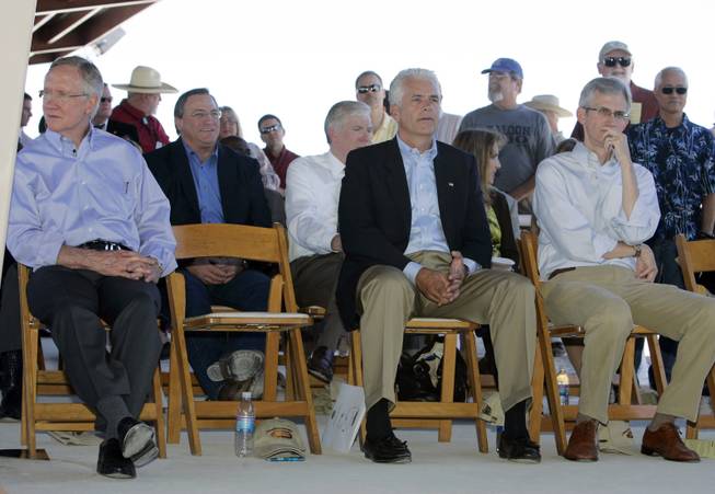 Senate Majority Leader Harry Reid, left, Sen. John Ensign, center, and Clark County Commissioner Rory Reid, right, listen to a speaker during the dedication of the Clark County Shooting Park at the north end of Decatur Boulevard Tuesday, Aug. 25, 2009.