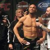 Randy Couture, center, along with his trainers (left to right) Quentin "The Dragon" Chong and Shawn Thompkins talks with Joe Rogan during Friday's weigh-in for UFC 102 Saturday night at the Rose Garden Arena in Portland, Ore. 