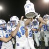 Basic High players celebrate keeping the ceremonial milk jug after defeating rivals Boulder City 26-0.