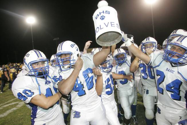 Basic High players celebrate keeping the ceremonial milk jug after defeating rivals Boulder City 26-0.