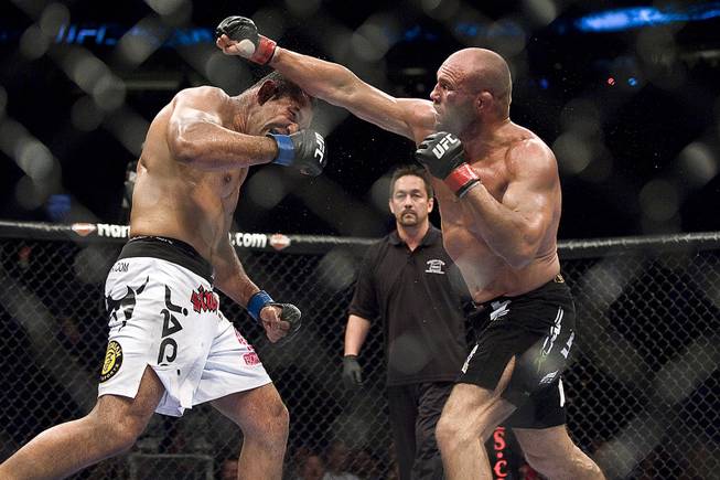 Antonio Nogueira, left, slips a punch thrown by Randy Couture in their fight at UFC 102 mixed martial arts match on Saturday Aug. 29, 2009 at the Rose Garden in Portland, Ore. Nogueira won the match by unanimous decision.