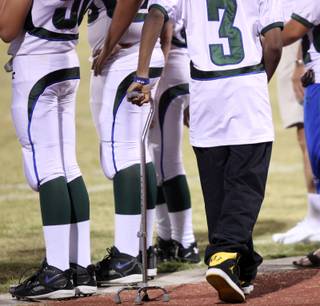 LaQuan Phillips hangs outs on the Green Valley sideline Friday as Green Valley took on Centennial.  Phillips bruised his spine and became temporarily paralyzed last year against Centennial while playing for Green Valley.

