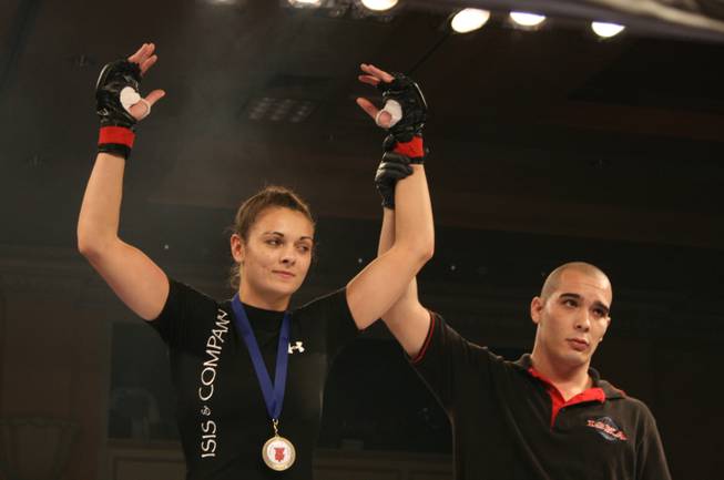 Team Canada's Bobbi-Jo Dalziel has her hand raised in victory after defeating Moa Palmer.
