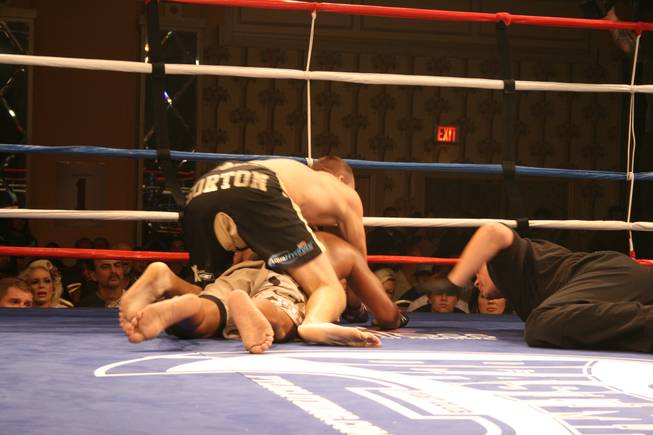 The referee stops Team Quest's Jon Gorton as he sinks in a successful rear naked choke on Team Tapout's Eric Bosley. 