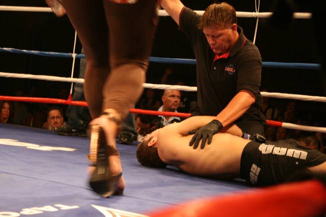 The ringside doctor rushes in to assist James Kytosaho after Forrest Cable puts him to sleep with a triangle choke at the end of the second round. 
