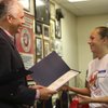 Sen. John Ensign congratulates Honor Pup Orianna Ellis while presenting her graduation certificate S