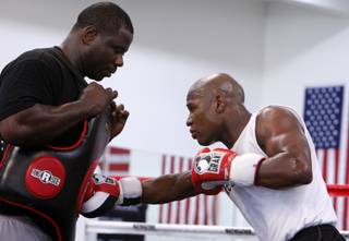 Floyd Mayweather Jr., right, works out with Nate Jones during an open workout at his Las Vegas gym Wednesday. Mayweather is preparing for his upcoming fight with Juan Manuel Marquez on Sept. 19 at the MGM Grand Garden Arena.