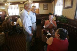 From left, Interior Secretary Ken Salazar and Sen. Harry Reid (D-Nev.) talk Friday with George and Bernice Stewart at the Searchlight Nugget. Reid and  Salazar were in town to formalize payment of $135.9 million for projects throughout Nevada, funded by the auction of federal land in the Las Vegas Valley.
