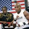 Floyd Mayweather Sr. watches from a distance while his son Floyd Mayweather Jr. works out for media members at his Las Vegas gym. Mayweather Sr. is helping his son prepare for a fight for the first time in nine years.