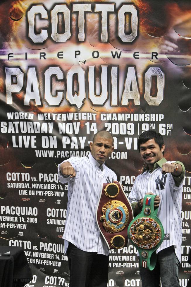 Boxers Manny Pacquiao, right, of the Philippines, and Miguel Cotto, of Puerto Rico pose for photographers during a news conference at Yankee Stadium to promote their WBO welterweight championship, Thursday, Sept. 10, 2009 in New York. The pair square off on Nov. 14 in Las Vegas.