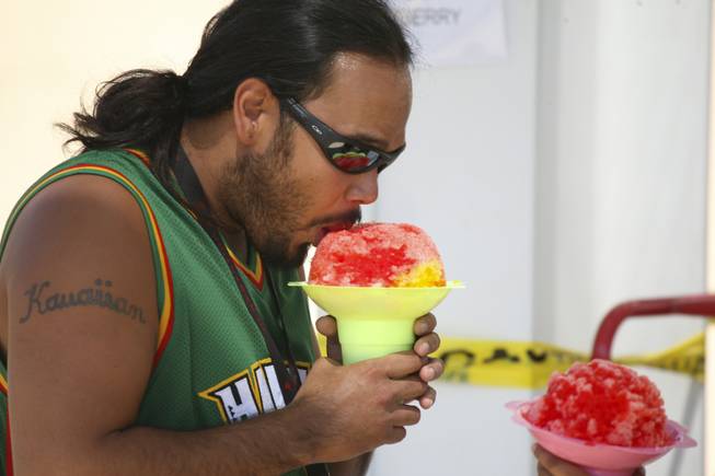 Festival-goers try to cool off by eating Hawaiian shaved ice Saturday at the Pacific Islands Festival at the Henderson Events Plaza.