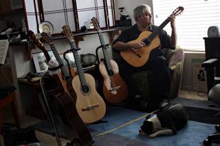 Classical guitarist Ricardo Cobo plays at his Summerlin home with dog, Olli, at his feet on Thursday, Sept. 10, 2009.