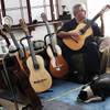 Classical guitarist Ricardo Cobo plays at his home in Summerlin with his dog, Olli, at his feet. Cob