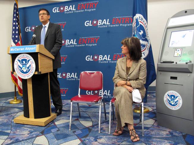 Carlos Martel, Los Angeles area port director for the U.S. Customs and Border Protection, speaks at a press conference to show off the new Global Entry kiosks at McCarran International Airport. Sitting on the right is Clark County Deputy Director of Aviation Rosemary Vassiliadis.