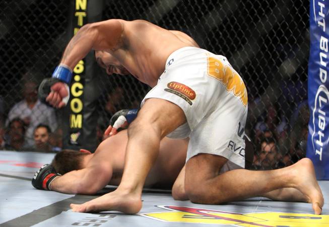 Vitor Belfort (blue) hits Rich Franklin (red) in the head during UFC 103 at American Airlines Center in Dallas. Belfort defeated Franklin.(Vernon Bryant/The Dallas Morning News)