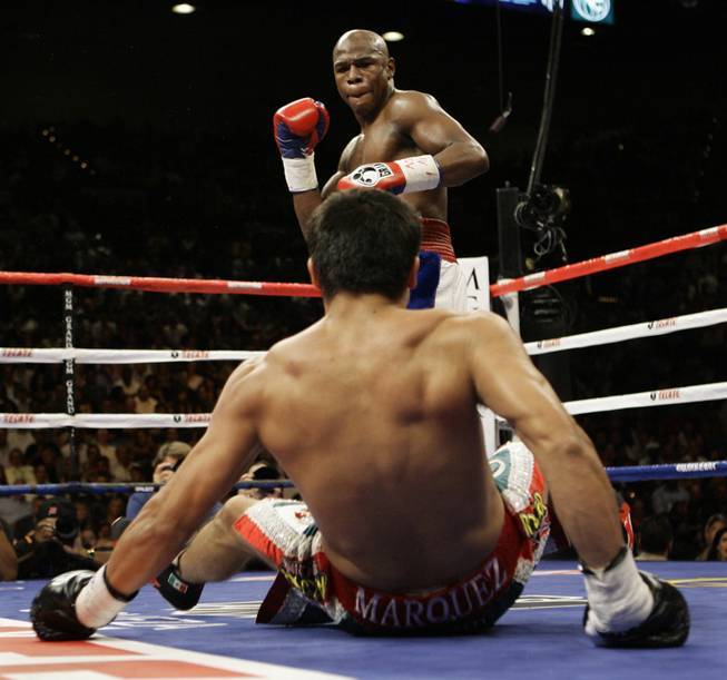 Floyd Mayweather Jr. steps back after knocking down Juan Manuel Marquez, of Mexico, during their welterweight boxing match in Las Vegas, Saturday, Sept. 19, 2009.