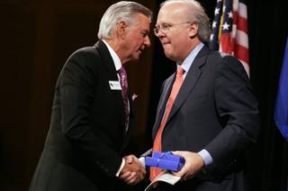 Karl Rove receives a gift from Nevada Policy Research Chairman Ranson Webster after Rove delivered the keynote address during the Nevada Policy Research Institute's 18th Anniversary Celebration at the Venetian on Wednesday.