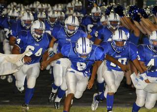 The Basic High football team runs onto the field during pregame festivities of the home opener against Coronado on Friday night.