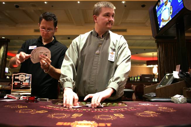 Chris Stones sets up his table with floor supervisor Ariel Leon, left, after returning to work as a dealer at the Suncoast Casino on Friday, September 4, 2009. Stones' craniectomy was apparently successful in removing the part of his brain that was causing seizures. Stones has not had a seizure since his final surgery over six weeks ago. 