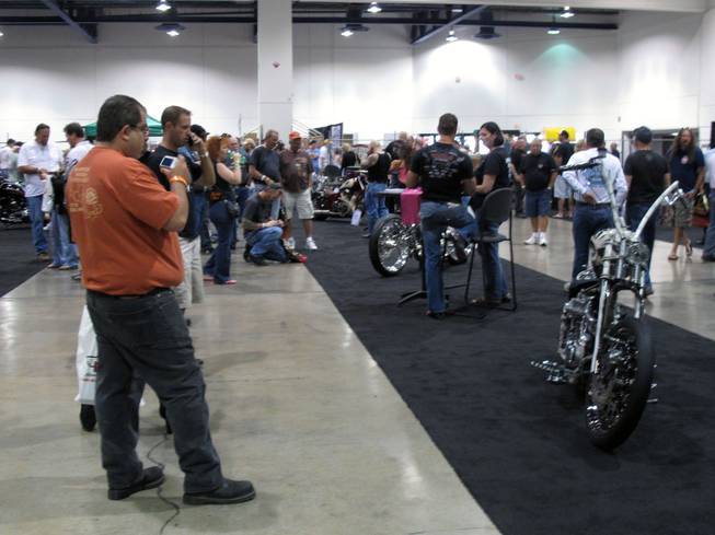 People slowly work their way through the lines of the custom motorcycles that were entered into this year's Artistry in Iron competition at the Las Vegas BikeFest at Cashman Center on Friday.