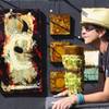Artist Angela Alvarez relaxes in the sunshine while hoping to sell one of her two-dimensional mixed media pieces on steel Sunday during the 47th Annual Art in the Park in Boulder City.