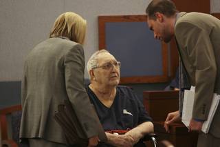 Deputy public defenders Kristine Kuzemka and Dan Silverstein, right, speak with Joseph Woods, 86, during a hearing before Justice of the Peace Nancy Oesterle on Oct. 8 at the Regional Justice Center. 