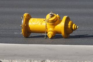 A fire hydrant lies in the street after a auto-pedestrian accident involving a 9-year-old boy on Las Vegas Boulevard South near the Mandalay Bay Thursday, Oct. 8, 2009. The boy and the driver of a dark blue GMC Yukon were both taken to hospitals. Police said the Yukon apparently ran up onto the sidewalk, then crashed into a fire hydrant.