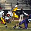 Dragons running back Dezerick Reed (7) goes airborne after being tripped up by Skyhawks strong safety Steven Scamorza during a play near the goalline on Friday night.