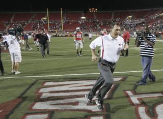 UNLV head coach Mike Sanford sprints off the field after a 59-21 loss to BYU Oct. 10 at Sam Boyd Stadium.